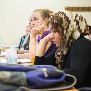 Female student focusing on instructor (not pictured)